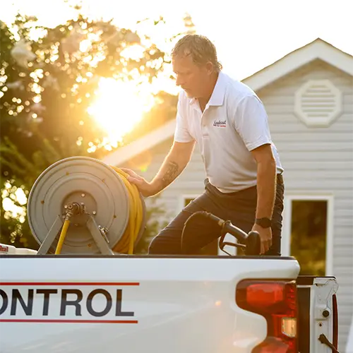 Lookout Pest Control Technician utilizing professional equipment from truck