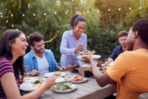 A group of friends gathering outdoors during the summer following bee removal services from Lookout Pest Control.